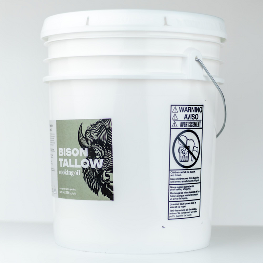 White bucket of bison tallow cooking oil with bison tallow label on a white background