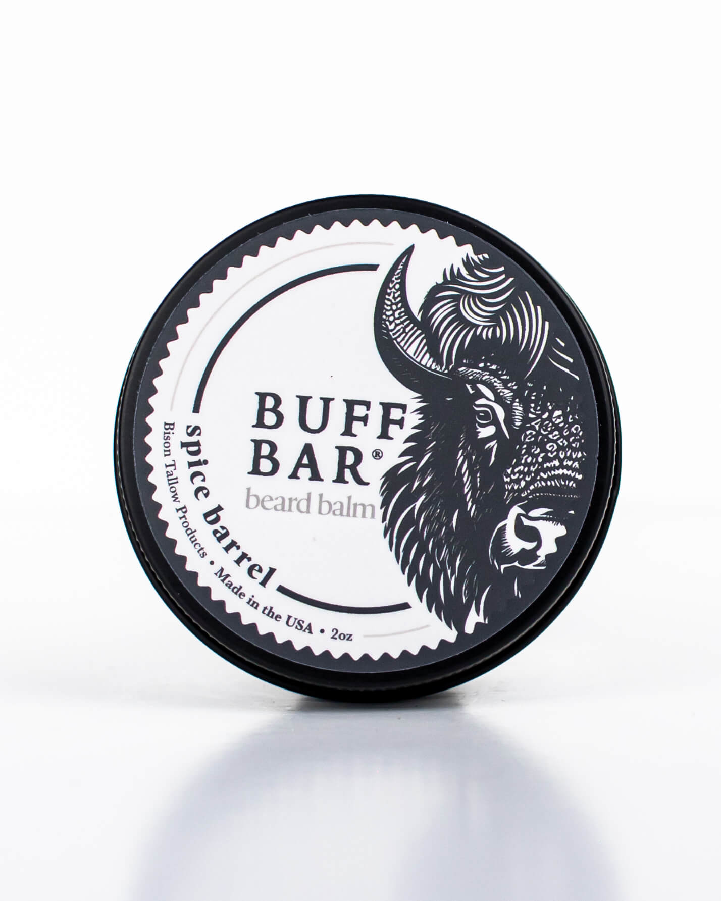 Buff Bar All-natural beard balm in a black tin with black lid and label featuring the Spice Barrell fragrance and the Buff Bar Bison illustration. The balm is on a white background.
