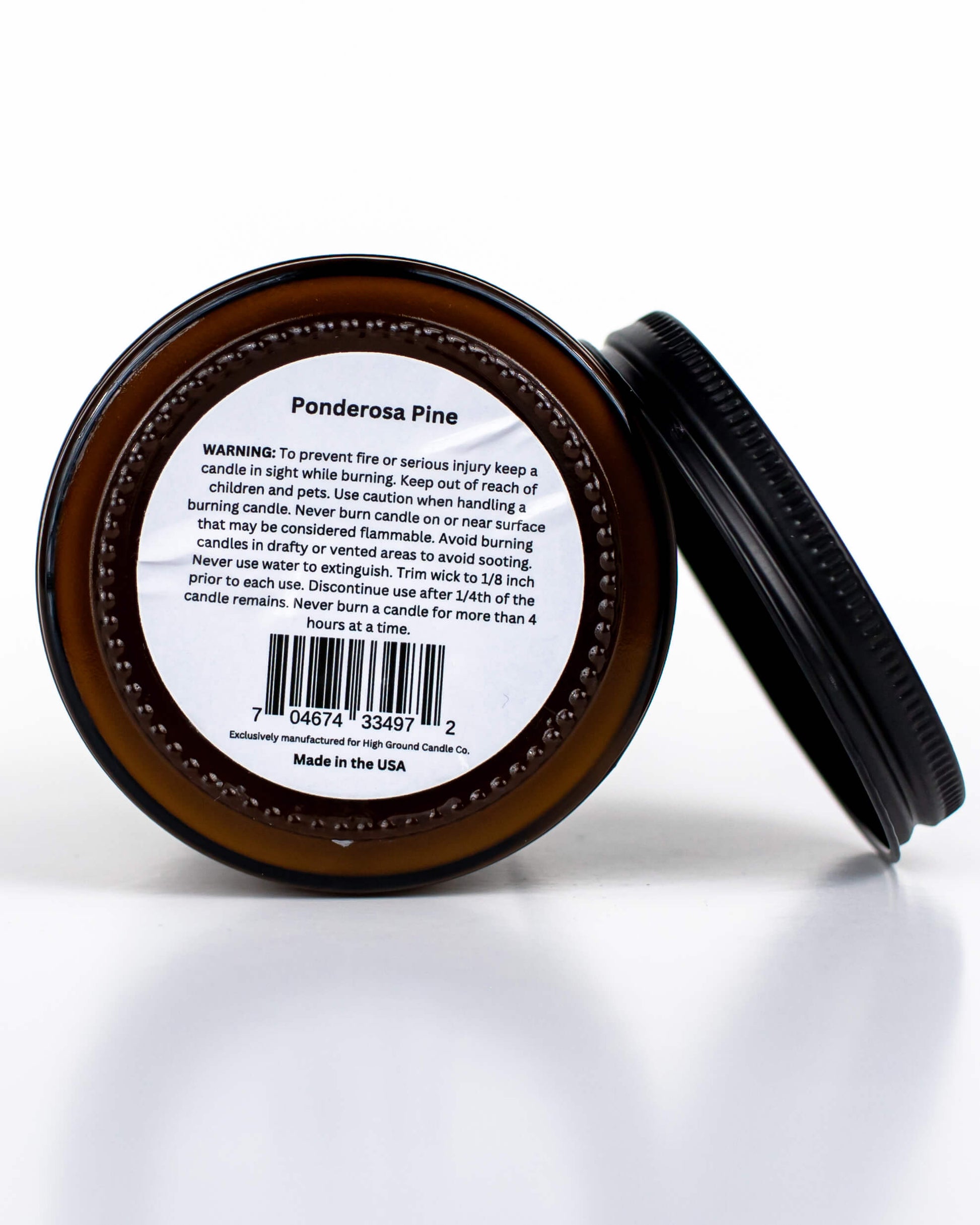 Buff Bar All-natural candle in a amber glass with black lid and warning label featuring the Ponderosa Pine fragrance. The candle is on a white background.