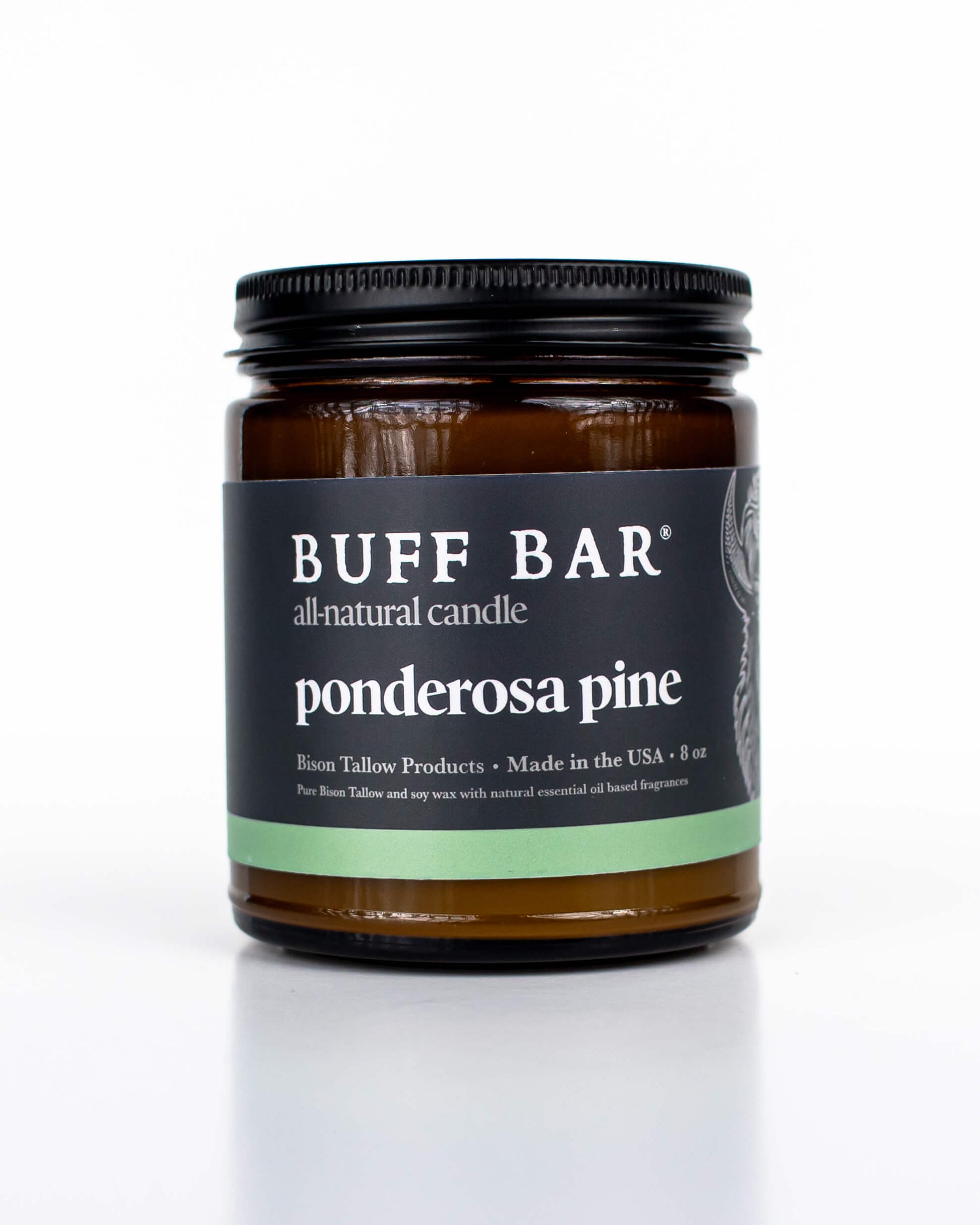 Buff Bar All-natural candle in a amber glass with black lid and label featuring the Ponderosa Pine fragrance and the Buff Bar Bison illustration. The candle is on a white background.