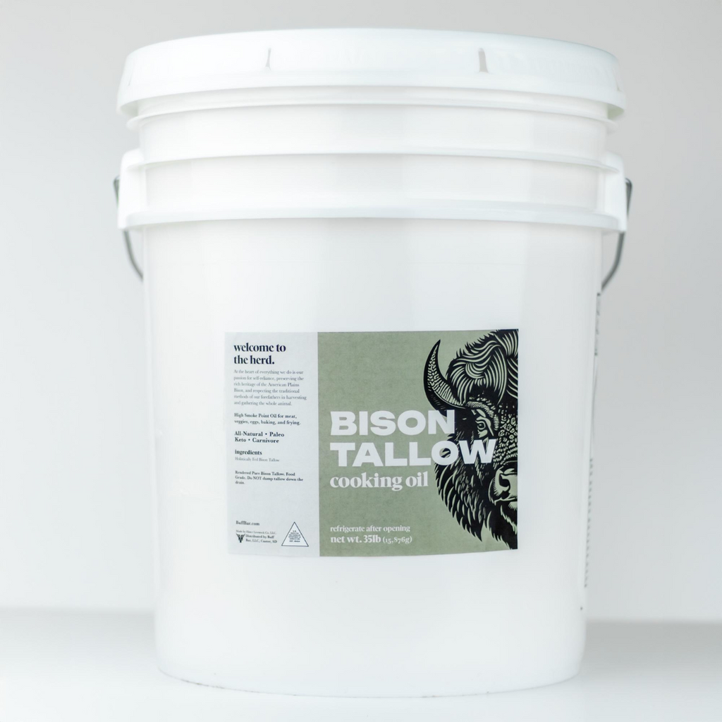 White bucket labeled 'Bison Tallow Cooking Oil' on a white background