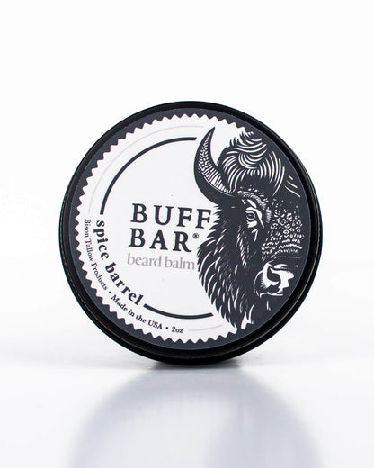 Buff Bar All-natural beard balm in a black tin with black lid and label featuring the Spice Barrell fragrance and the Buff Bar Bison illustration. The balm is on a white background.