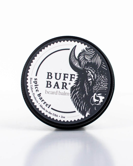 Buff Bar All-natural beard balm in a black tin with black lid and label featuring the Spice Barrell fragrance and the Buff Bar Bison illustration. The balm is on a white background.