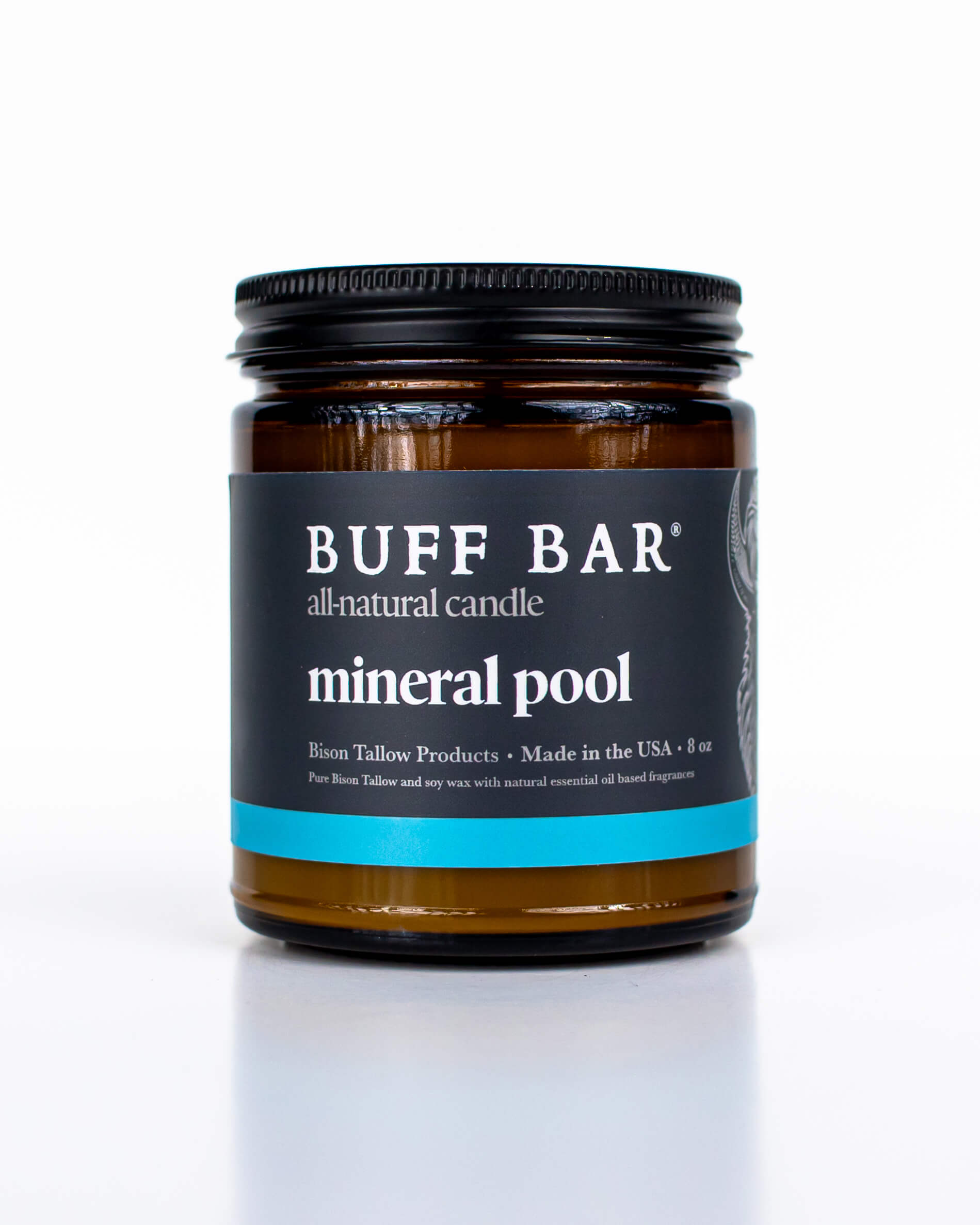 Buff Bar All-natural candle in a amber glass with black lid and label featuring the Mineral Pool fragrance and the Buff Bar Bison illustration. The candle is on a white background.