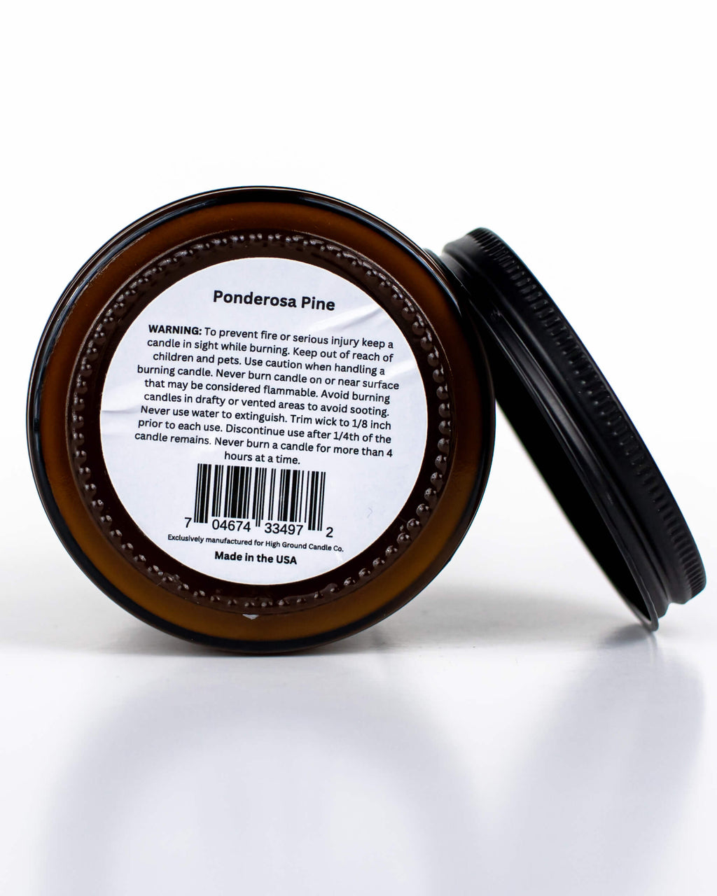 Buff Bar All-natural candle in a amber glass with black lid and warning label featuring the Ponderosa Pine fragrance. The candle is on a white background.