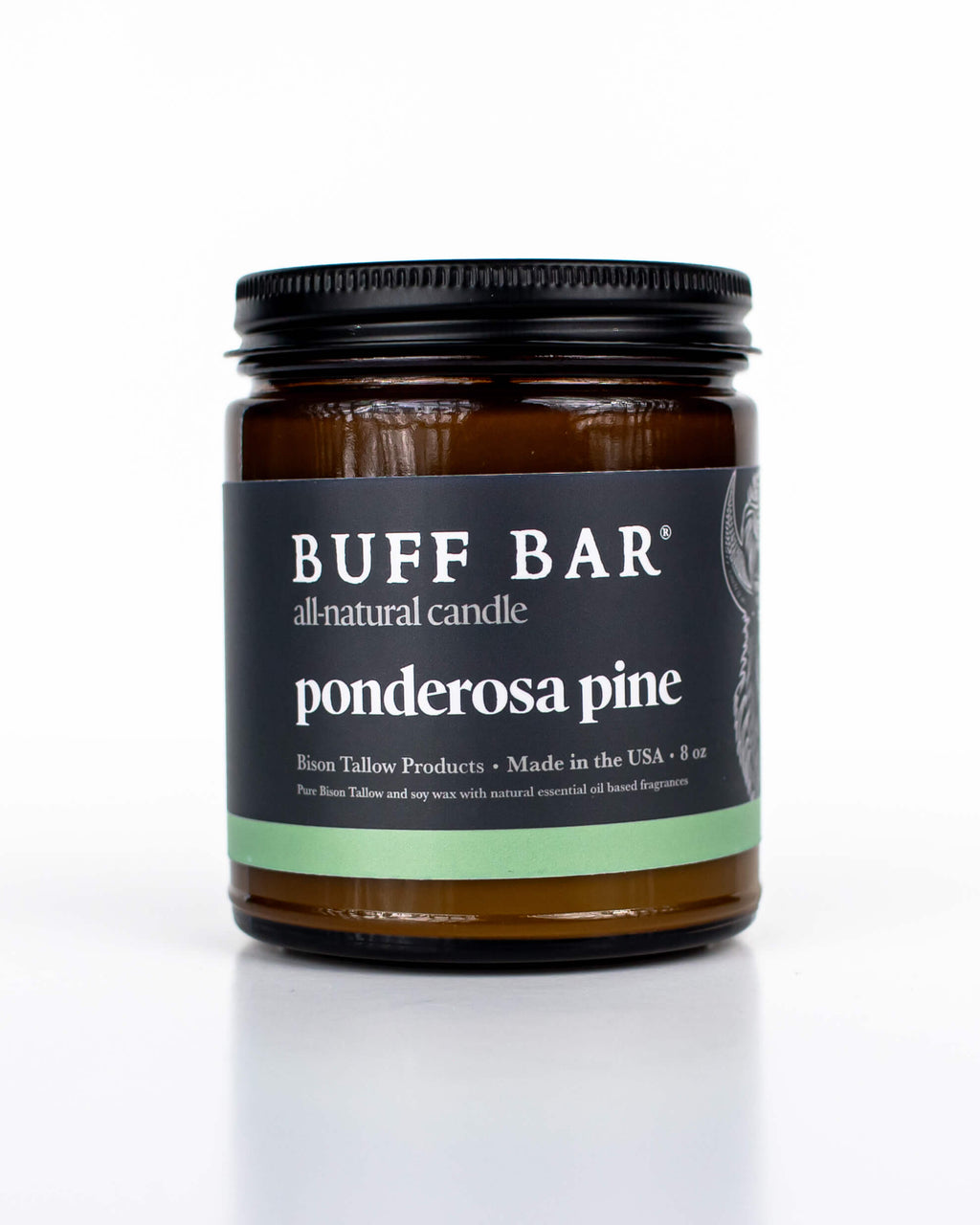 Buff Bar All-natural candle in a amber glass with black lid and label featuring the Ponderosa Pine fragrance and the Buff Bar Bison illustration. The candle is on a white background.