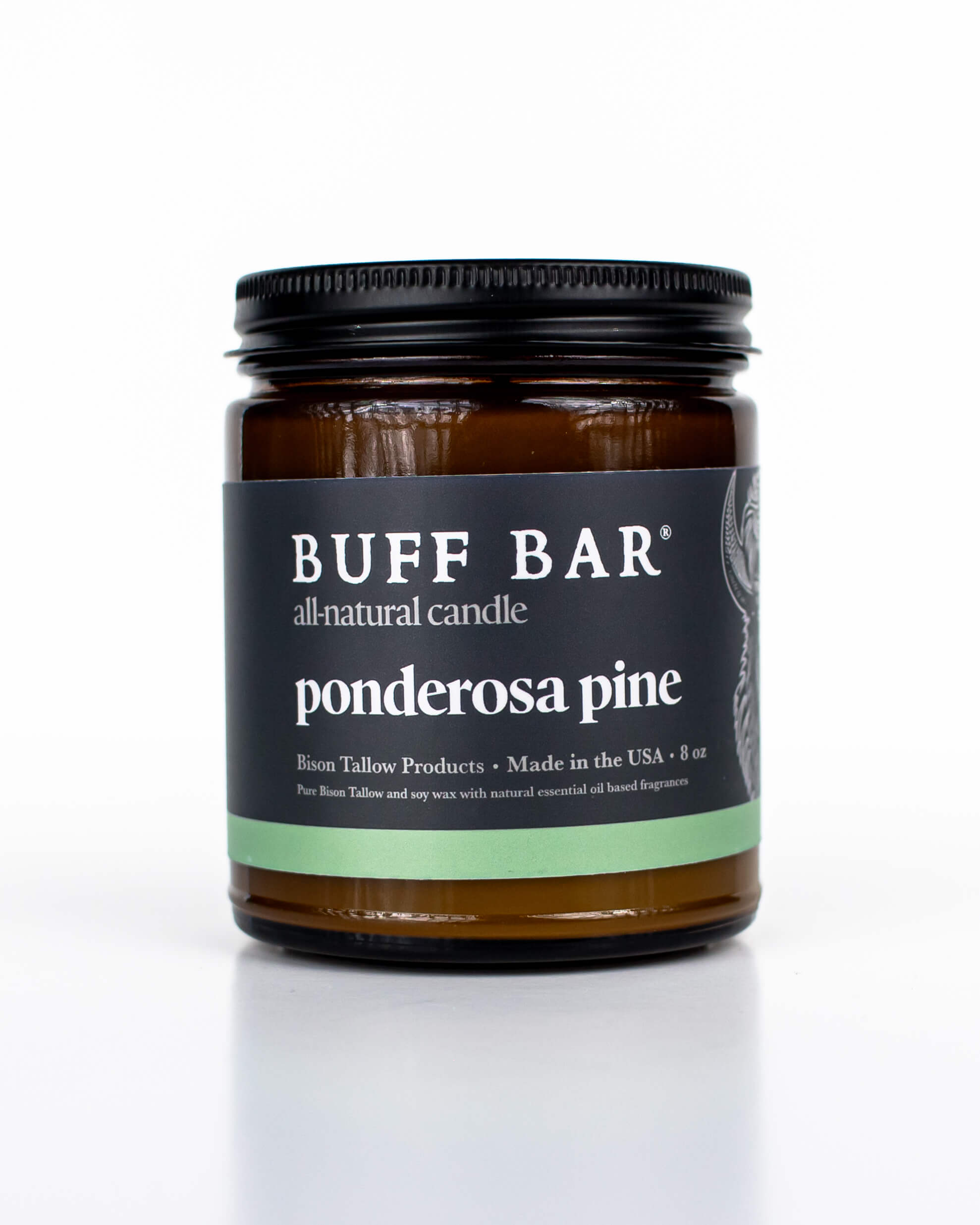 Buff Bar All-natural candle in a amber glass with black lid and label featuring the Ponderosa Pine fragrance and the Buff Bar Bison illustration. The candle is on a white background.