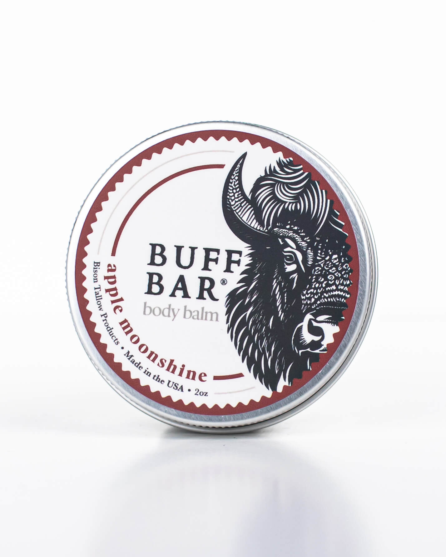 Buff Bar All-natural body balm in a tin and label featuring the Apple Moonshine fragrance and the Buff Bar Bison illustration. The tin is on a white background.