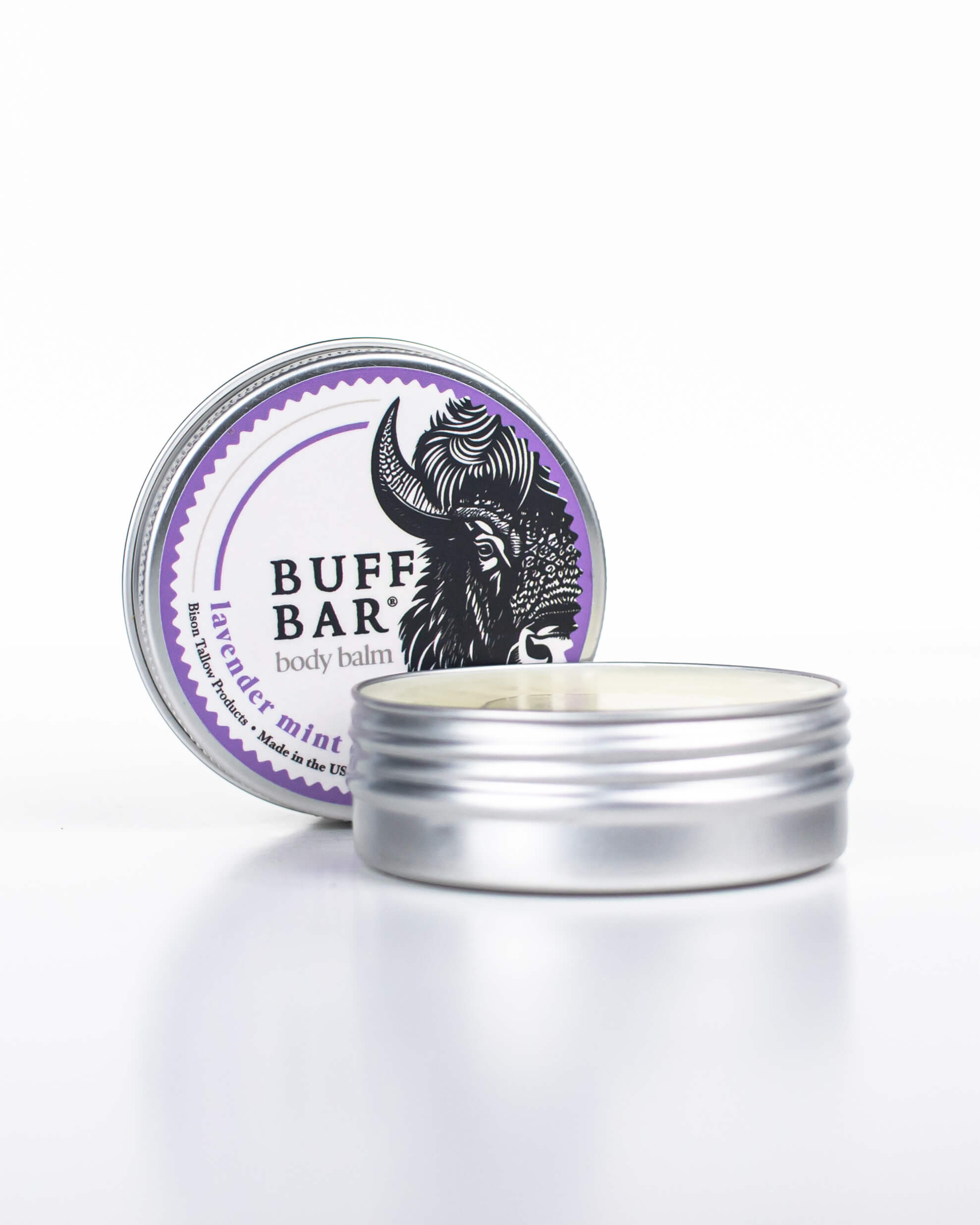 Buff Bar All-natural body balm in a tin and label featuring the Lavender Mint fragrance and the Buff Bar Bison illustration. The tin is on a white background.
