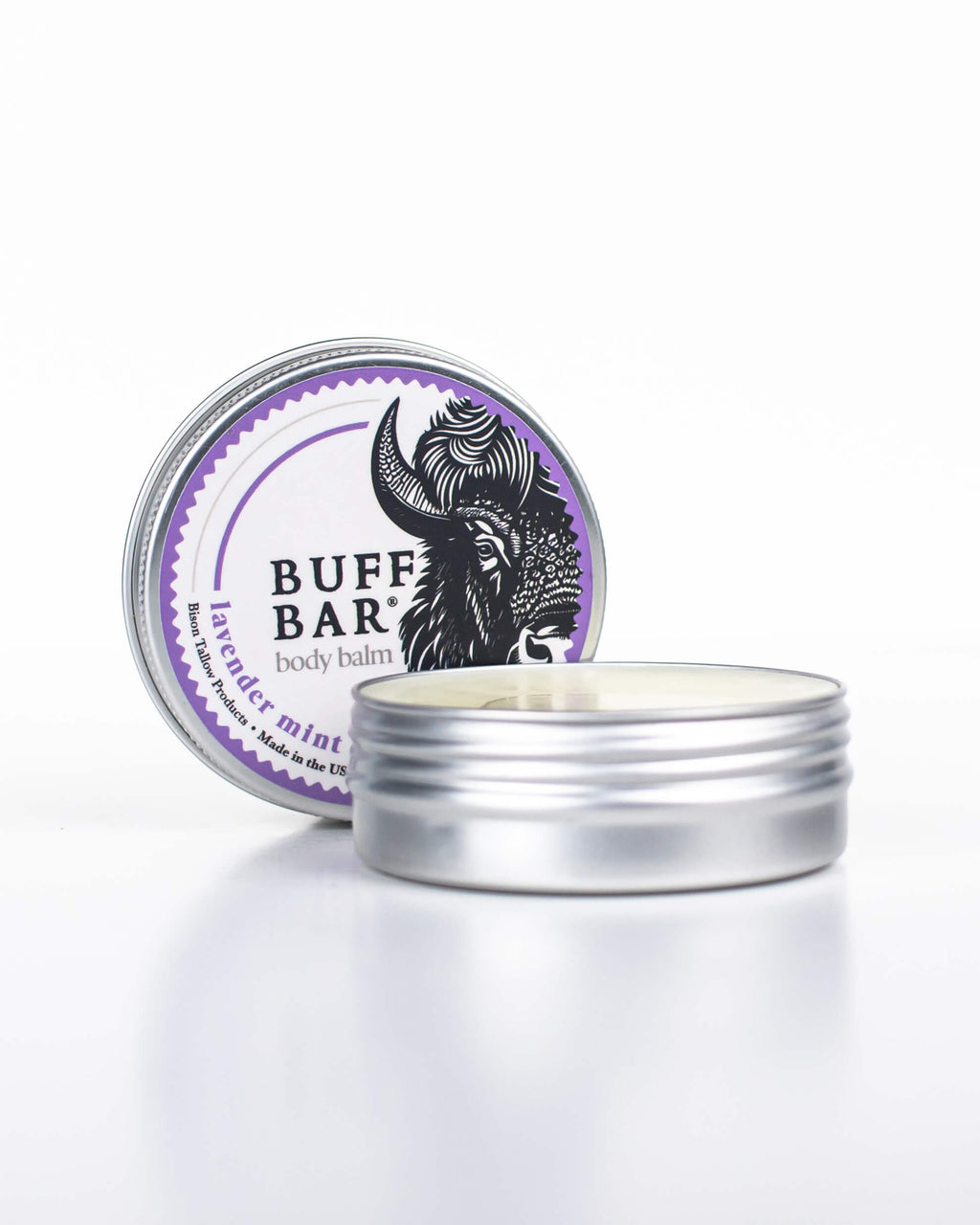 Buff Bar All-natural body balm in a tin and label featuring the Lavender Mint fragrance and the Buff Bar Bison illustration. The tin is on a white background.