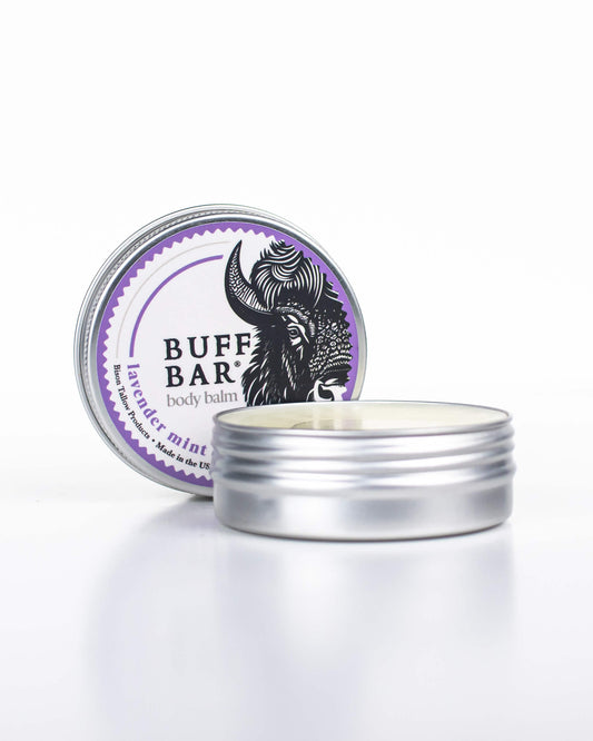 Buff Bar All-natural body balm in a tin and label featuring the Lavender Mint fragrance and the Buff Bar Bison illustration. The tin is on a white background.