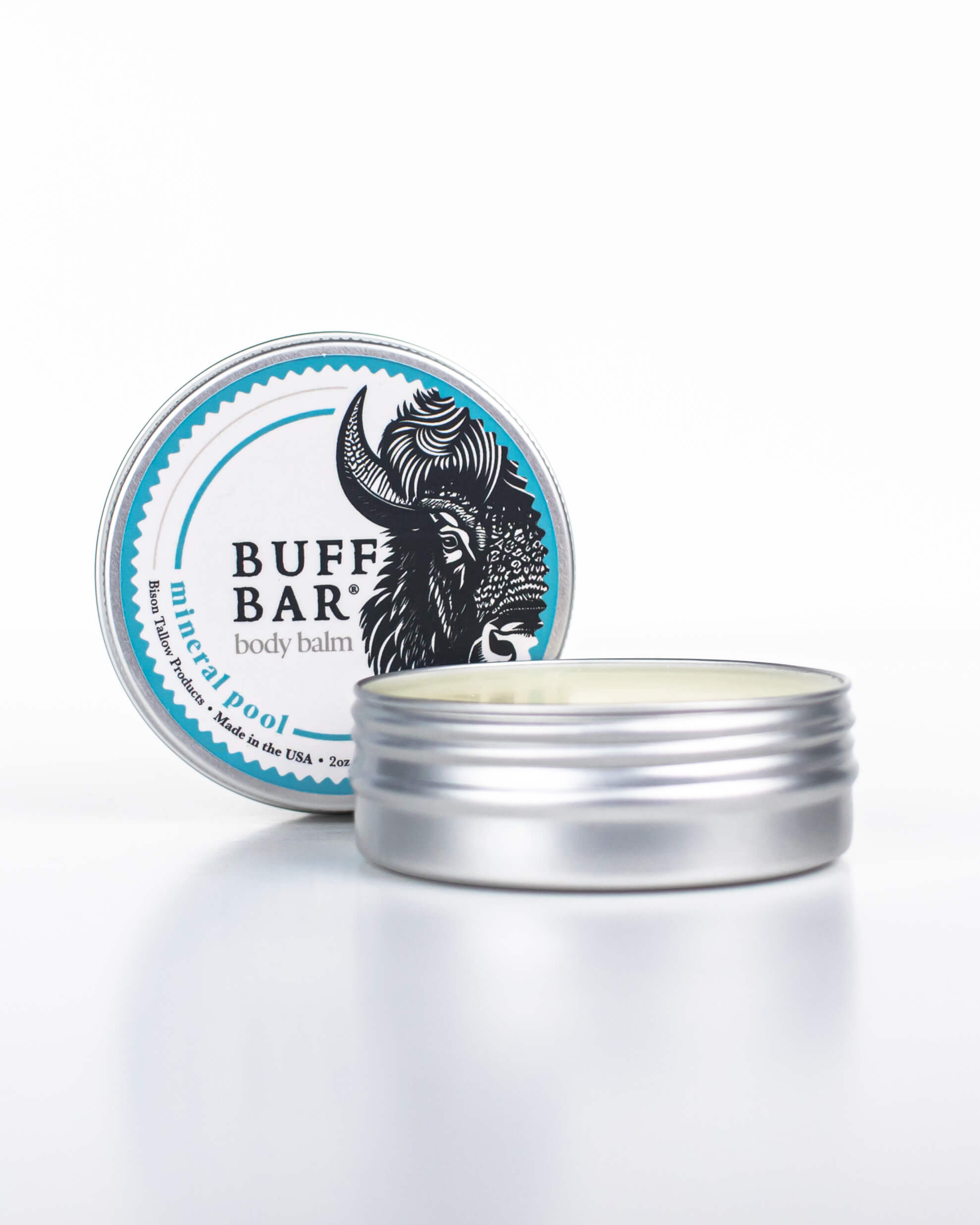 Buff Bar All-natural body balm in a tin and label featuring the Mineral Pool fragrance and the Buff Bar Bison illustration. The tin is on a white background.