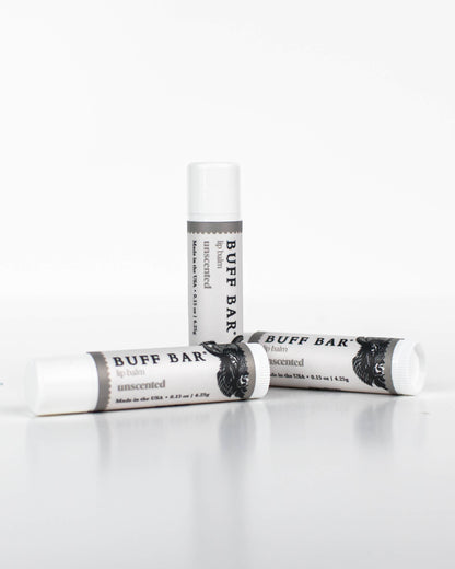 Three tubes of Buff Bar All-Natural lip balm featuring the Unscented Fragrance on a white background.